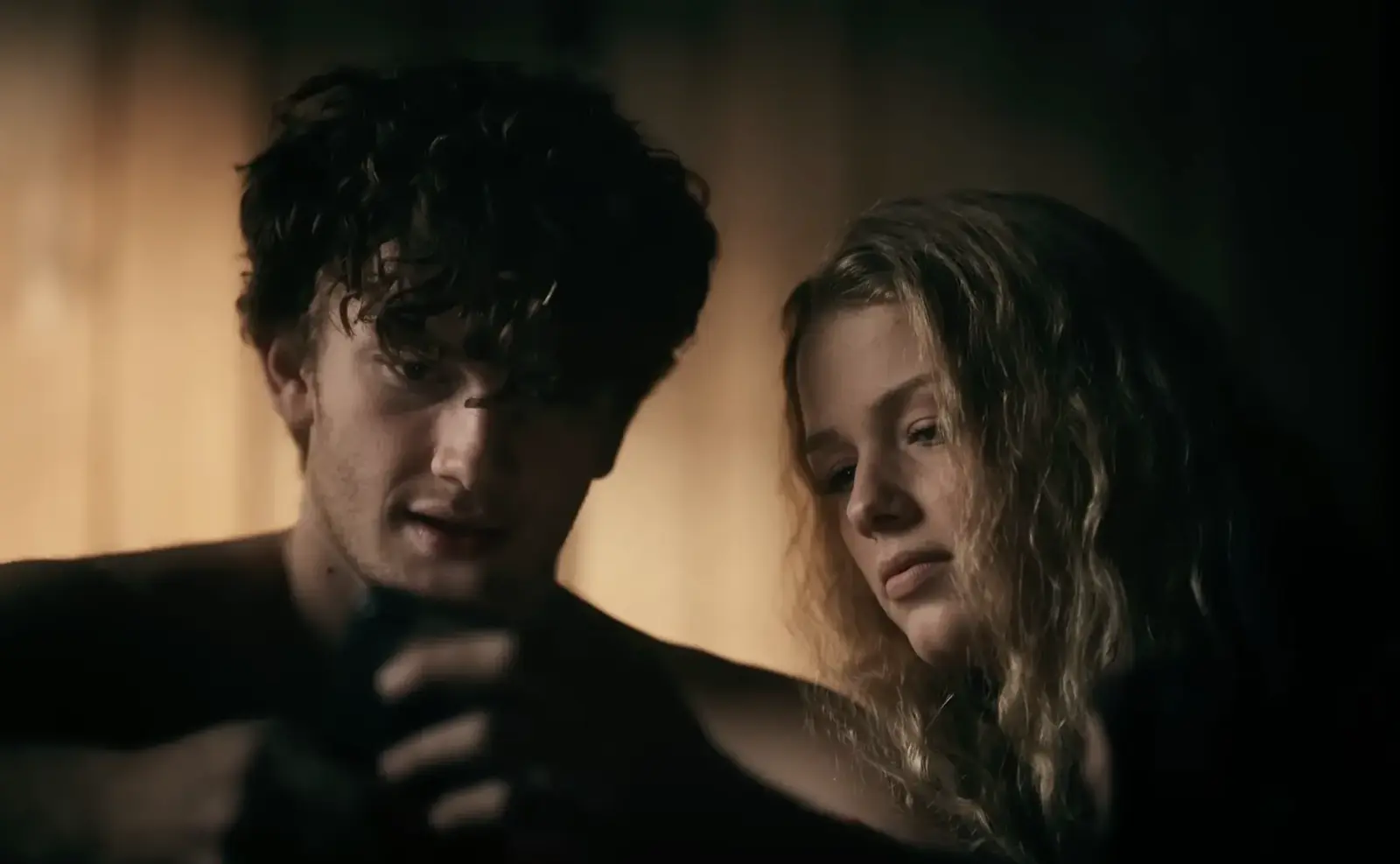 A boyfriend and girlfriend watch a porn video on his phone